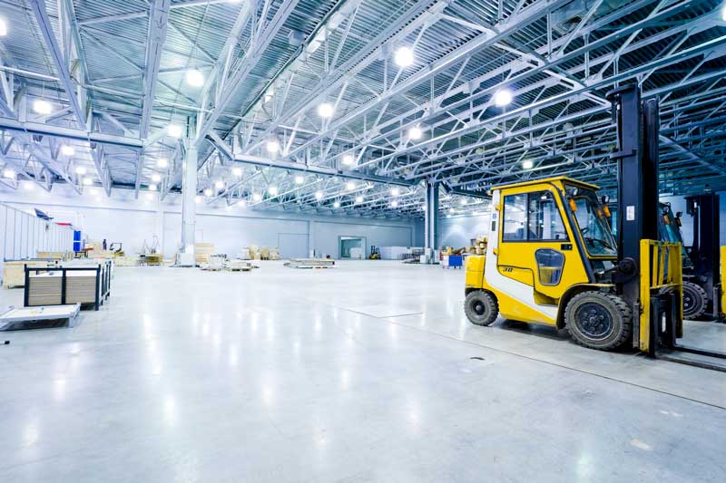 Warehouse with bright lights and forklift