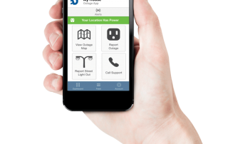 hand holding a cell phone with Dakota Electric's outage app displayed