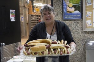 Julie Simonsen holding a tray of hot dogs. 