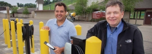 Dave Solner and Don McClure, co-owners of Buck Hill Ski Area stand next to their new Tesla level 2 chargers installed as part of Tesla's Destination Charging program.