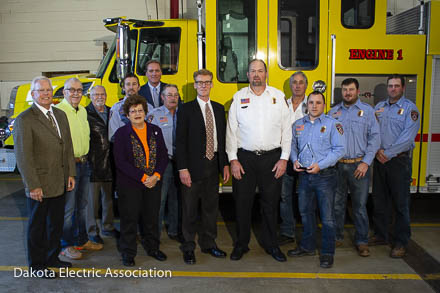 group posing by fire truck