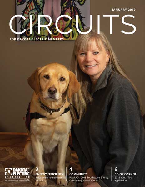 Cover of January issue of Circuits. Pictured are Linda Ball, founder and executive director of PawPADs, and Tory, the organization's ambassador dog