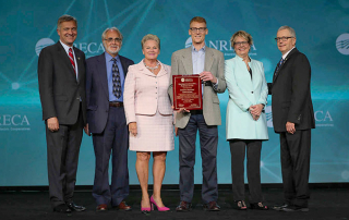 directors on stage with award
