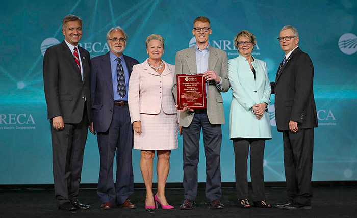 directors on stage with award