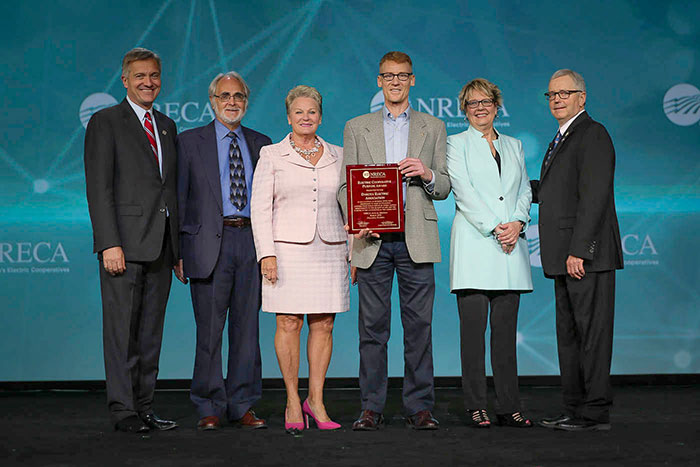 directors on stage with award