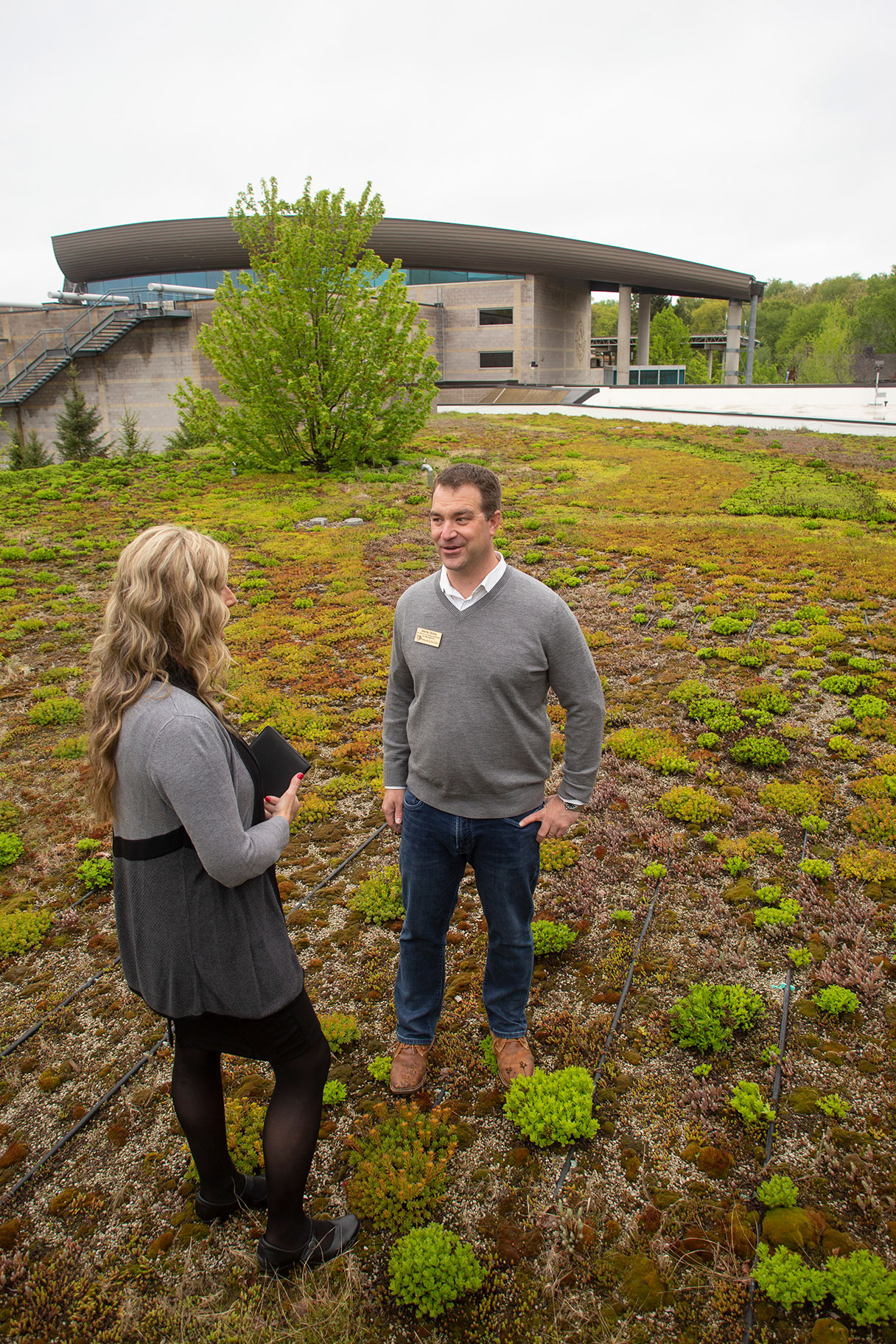 Jane Siebenaler of Dakota Electric and Derik Otten of the Minnesota Zoo discuss the Environmental Education Center’s vegetative, or green, roof.