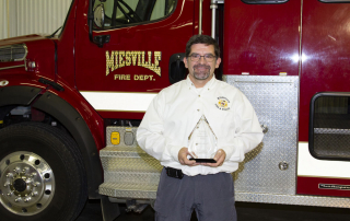 man standing with trophy