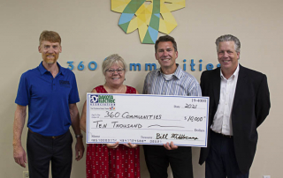 4 people with big check