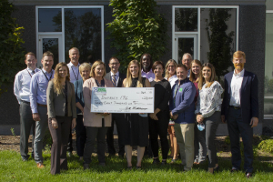 large group of people holding large check